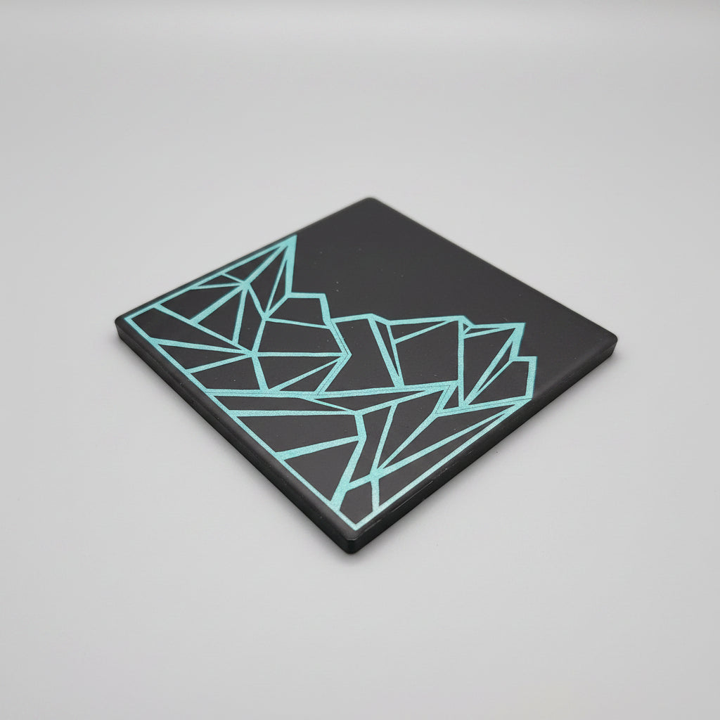 Glowing geometric design on a black surface with a dark background